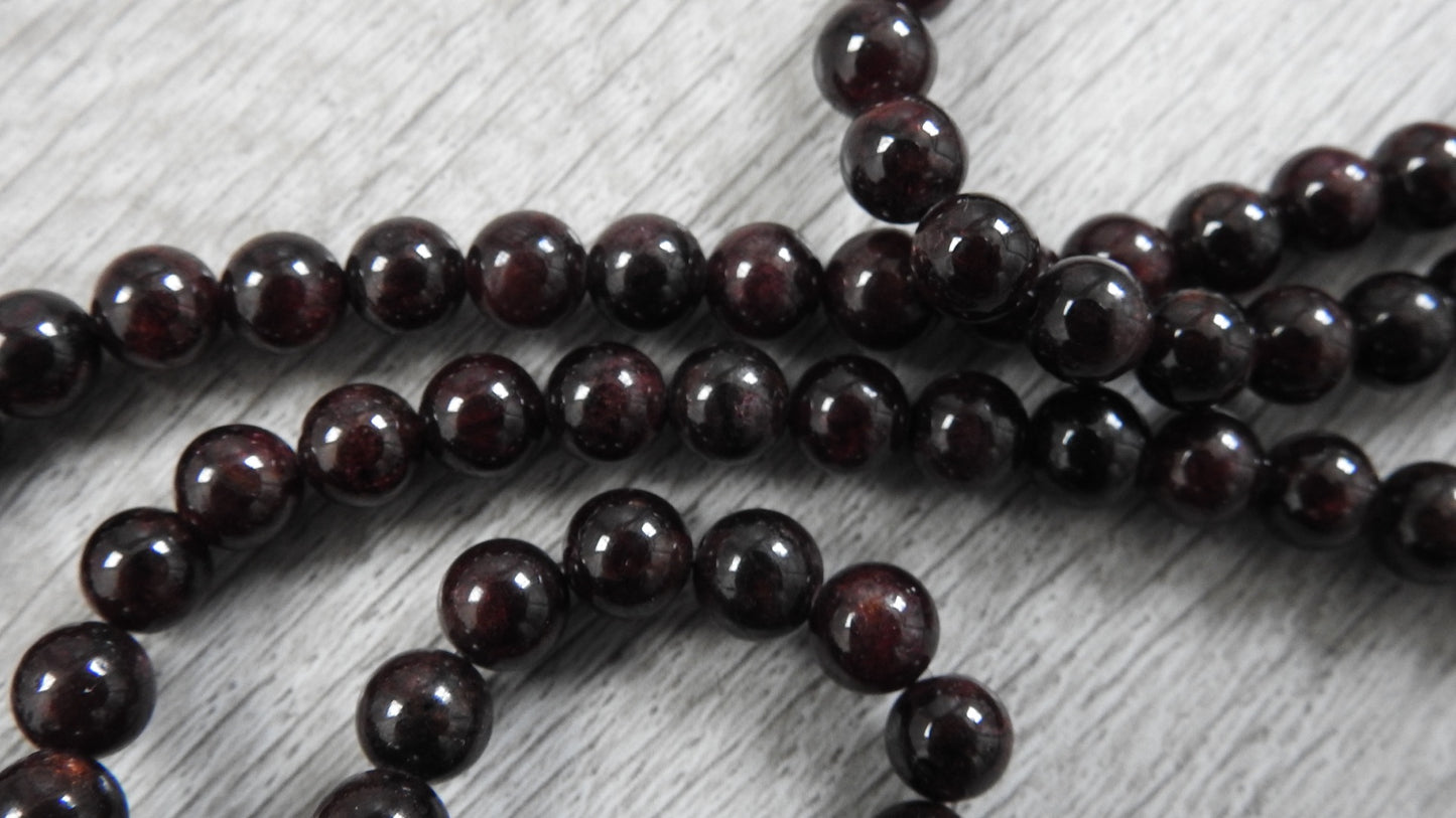 Final glamour shot of sterling silver rustic leaf pendant with garnet showcasing complete one-of-a-kind design capturing fond Markeaton Park memories.