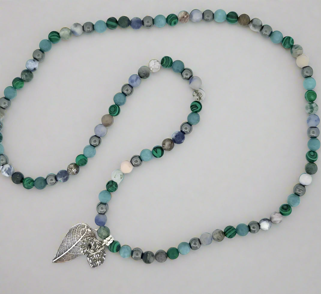 Final glamour shot of sterling silver hybrid pendant showcasing complete land-and-sea inspired design.