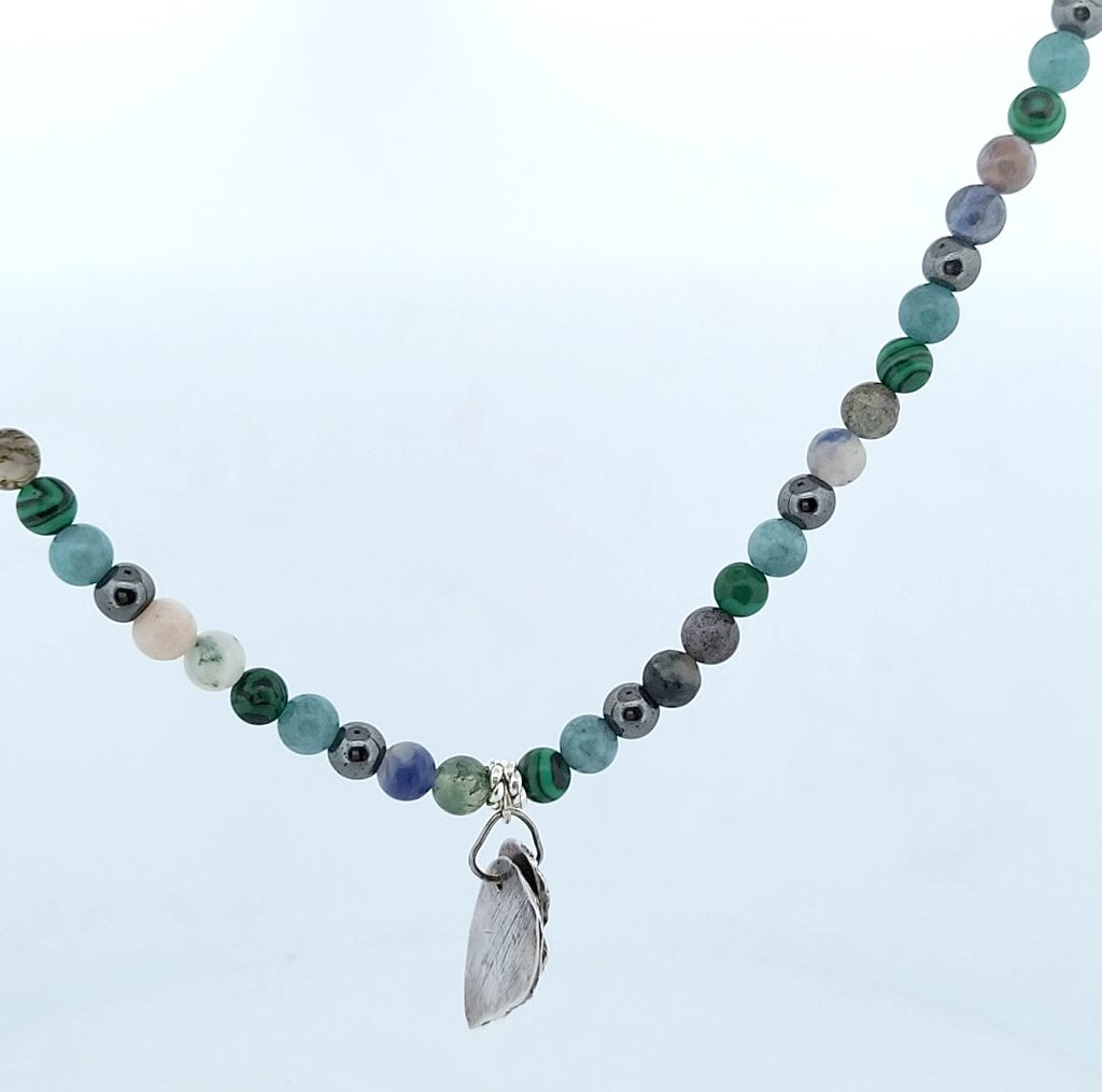 Reverse side of hybrid harmony pendant displaying sterling silver back finishing and artisan craftsmanship.