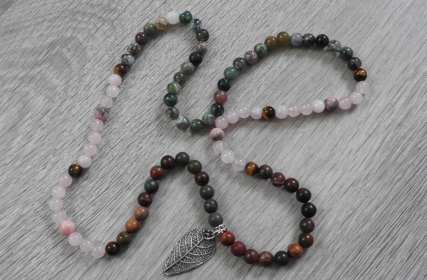 Full view of sterling silver leaf necklace showing chain and pendant combination with Diwali-inspired warm gemstone colours.