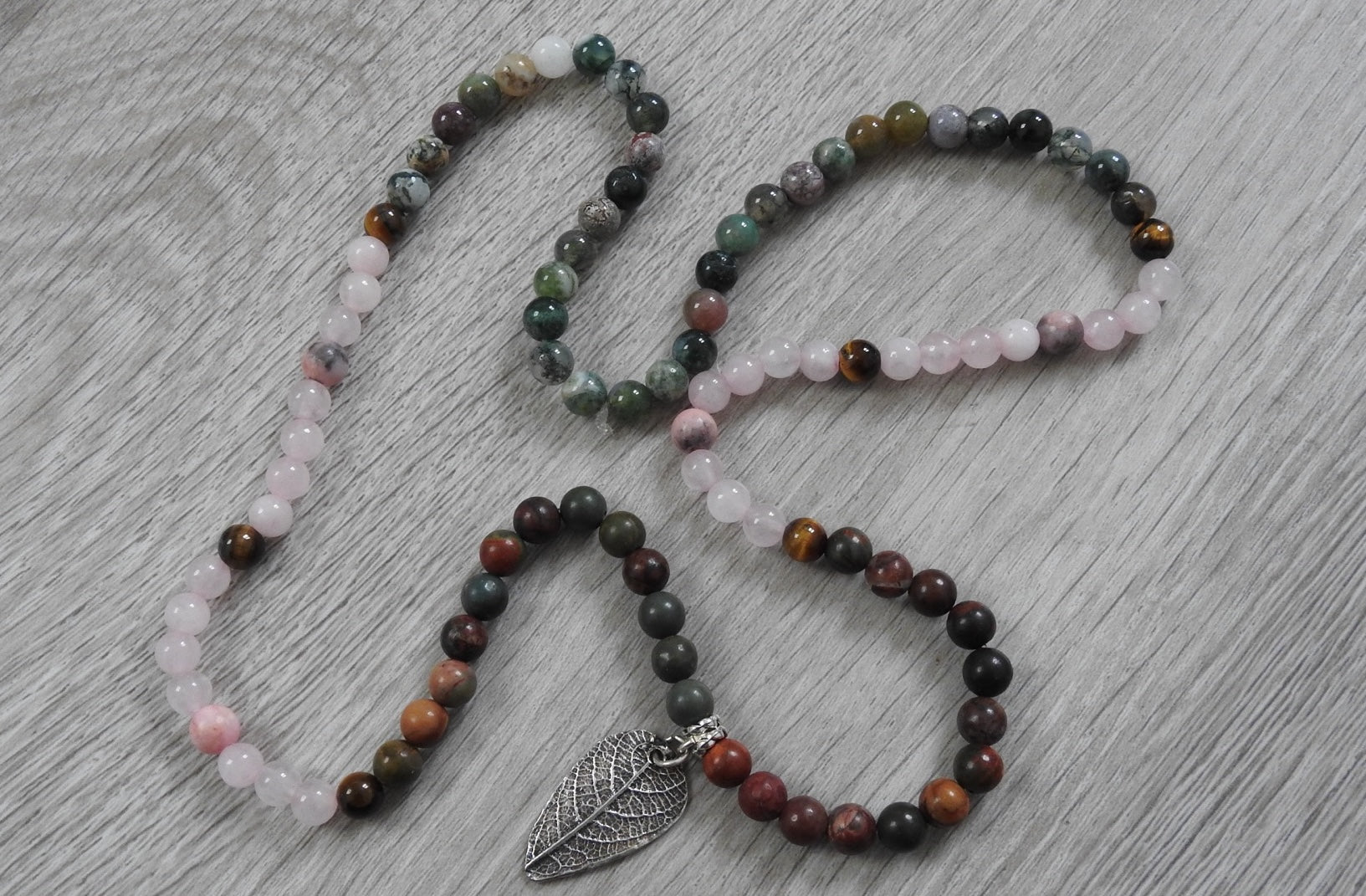 Full view of sterling silver leaf necklace showing chain and pendant combination with Diwali-inspired warm gemstone colours.