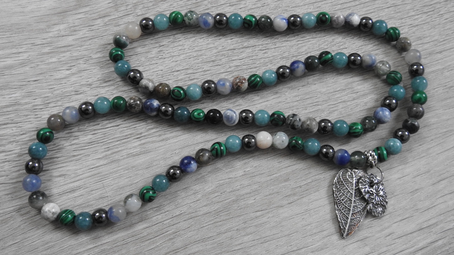 Angled view of sterling silver hybrid pendant highlighting raw textures of nature where woodland meets Atlantic shores.