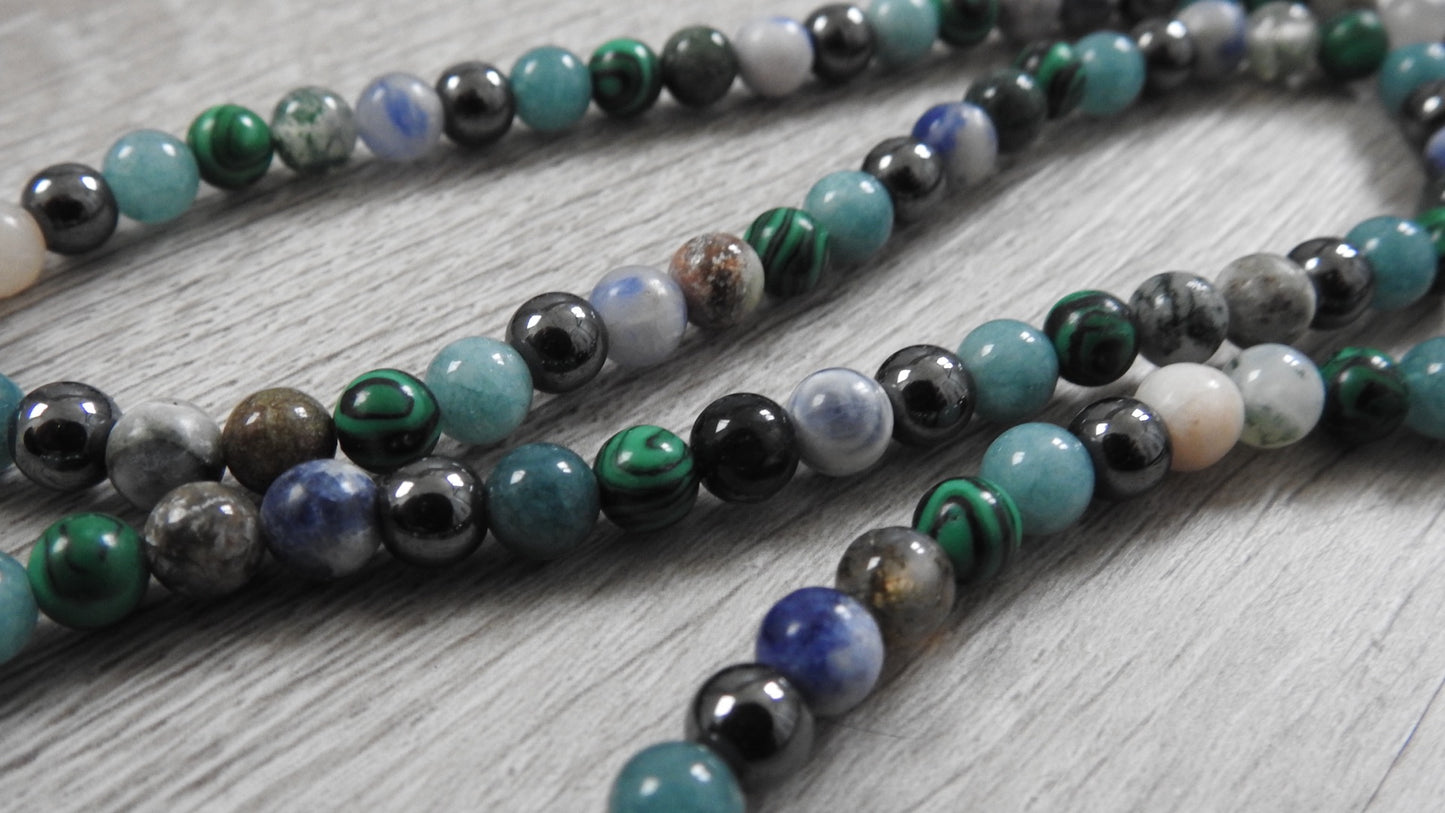 Close-up detail of sterling silver hybrid pendant showing intricate leaf and coral texture fusion with antique silver finish.