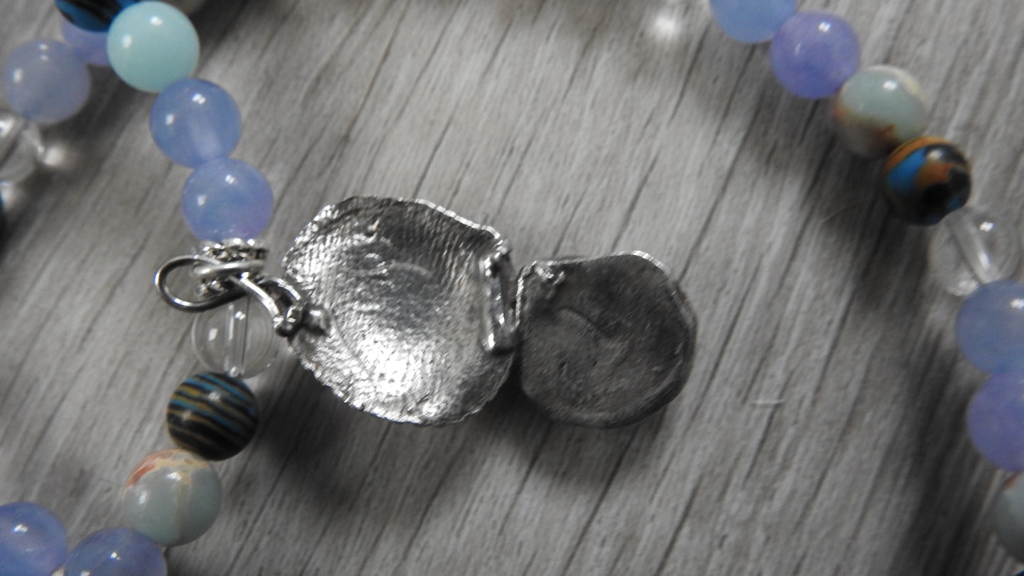 Reverse side of sea shell pendant displaying sterling silver back finishing and artisan detailing with antique silver accents.