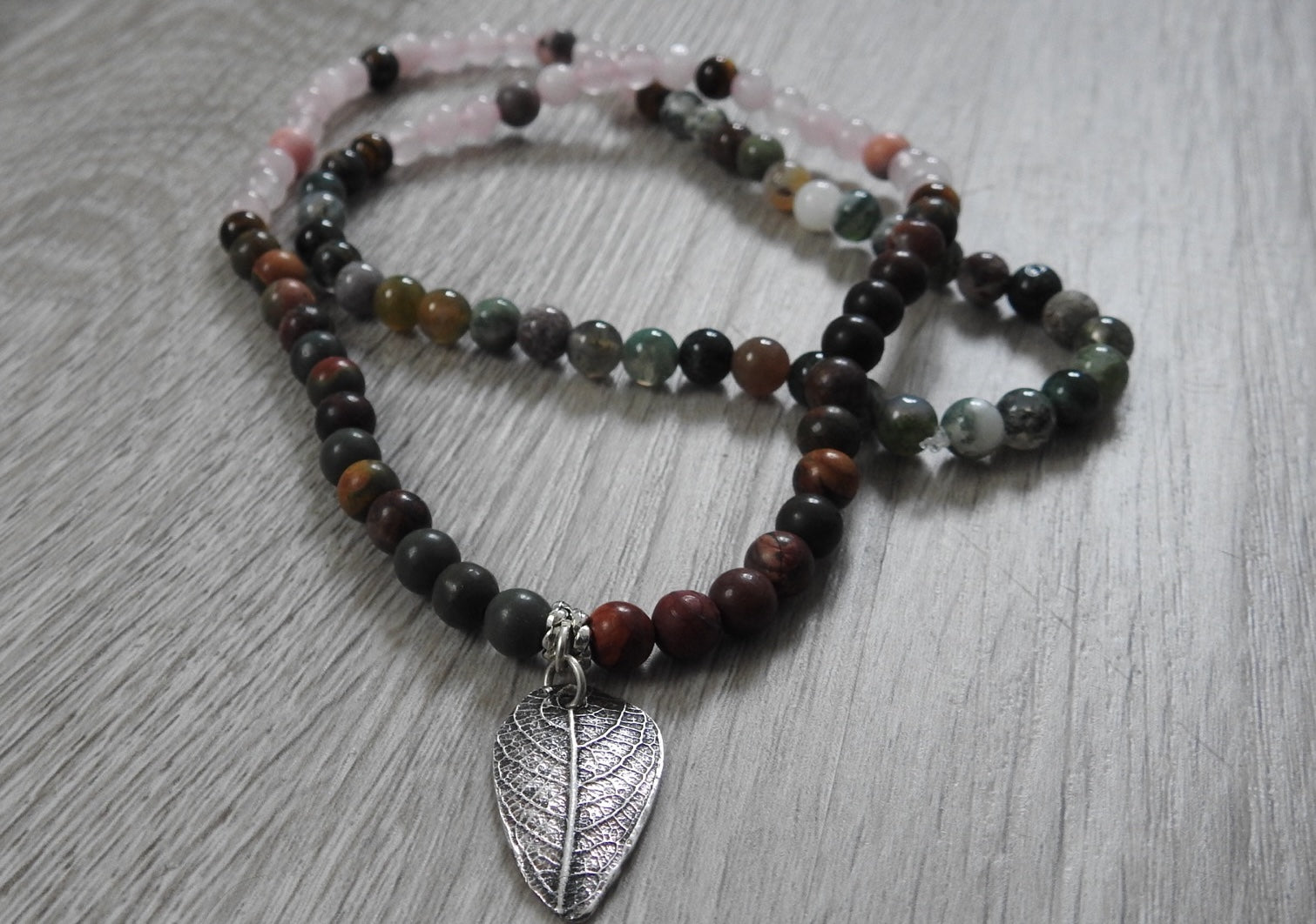 Reverse side of rustic leaf pendant displaying sterling silver and antique silver finishing with artisan craftsmanship details.