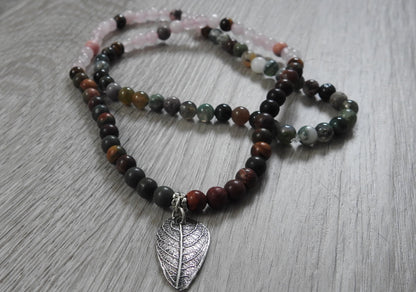 Reverse side of rustic leaf pendant displaying sterling silver and antique silver finishing with artisan craftsmanship details.